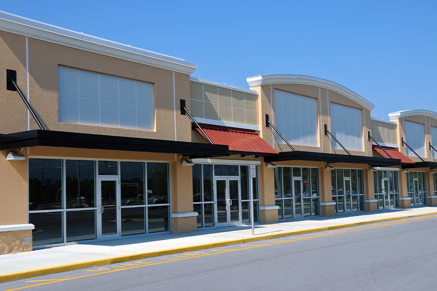Vacant Building Insurance - Vacant Retail Buildings in a New Shopping Center on a Sunny Day